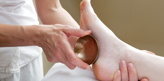 Massaging Foot with Kansa Vatki